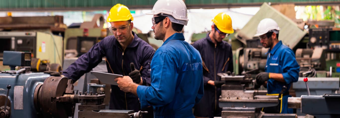 mechanics working with protective workwear uniform & equipment