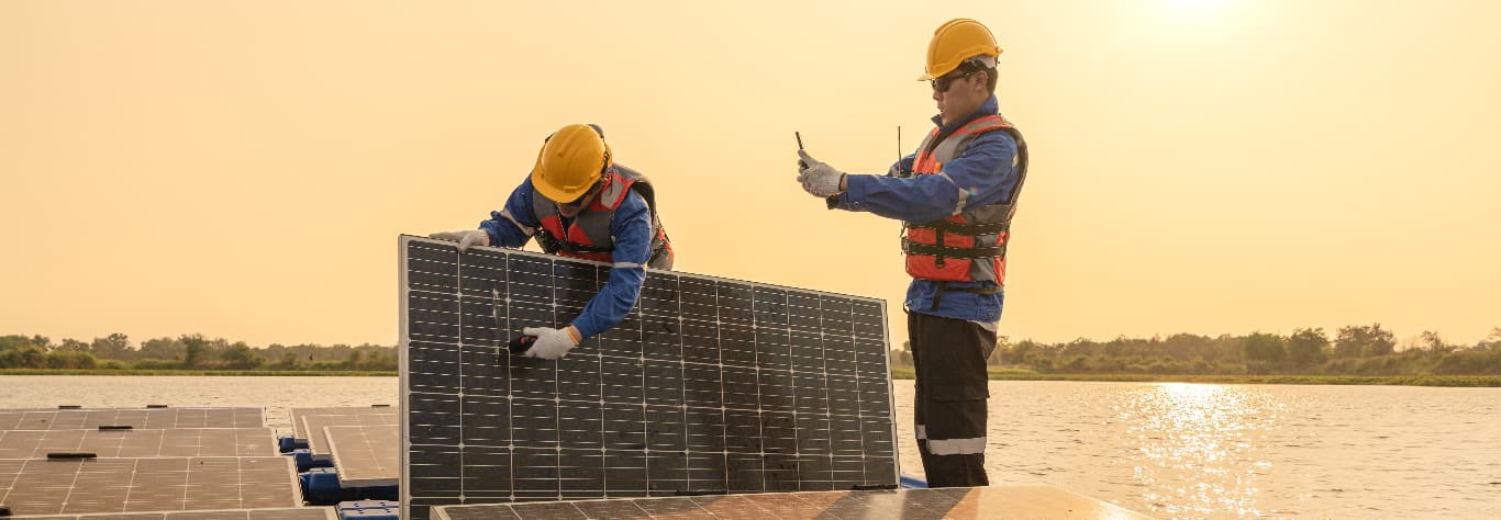 engineers looking at solar panels outside